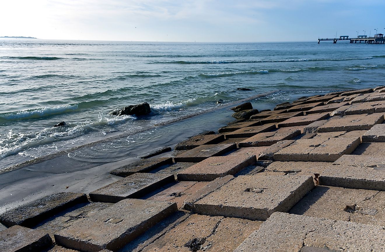 A breakwall on a beach in Tampa Bay, Florida suggests rising sea levels and climate change denial. Image credit:  Joanne Dale/Shutterstock.com