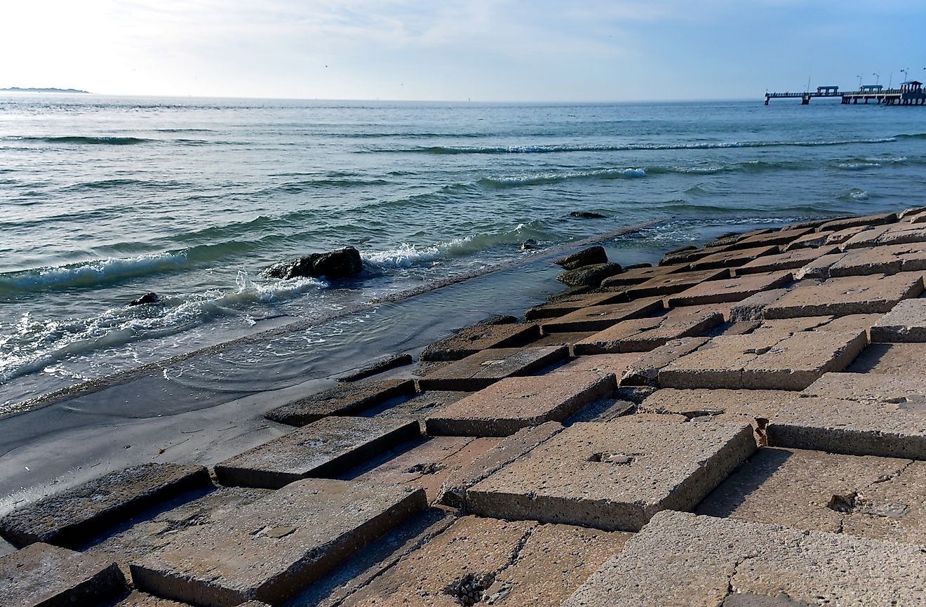 A breakwall on a beach in Tampa Bay, Florida suggests rising sea levels and climate change denial. Image credit: Joanne Dale/Shutterstock.com