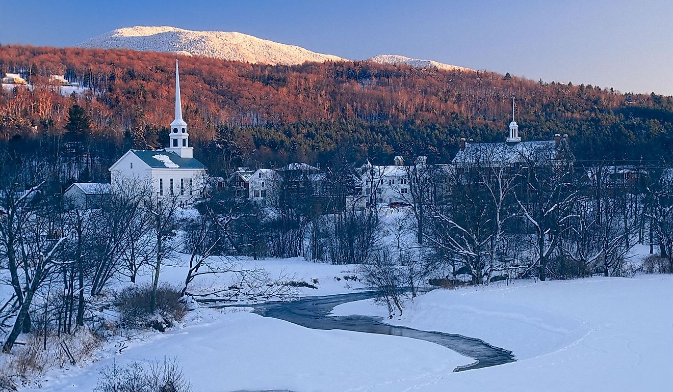 Sunset in the mountains behind the community church in the village of Stowe Vermont, USA.