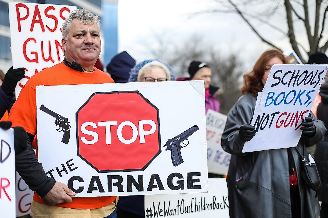 Protesters gather outside of the National Rifle Association headquarters for a vigil in remembrance of the 2012 Sandy Hook Elementary School massacre in Newtown. Image credit: Nicole Glass Photography/Shutterstock.com