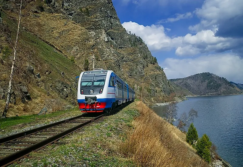 A passenger train on the Trans-Siberian Railway traveling through Irkutsk Oblast in the springtime.