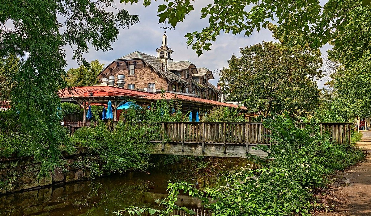 Small wooden bridge crossing the Delaware River Canal with reflections in Lambertville, New Jersey.
