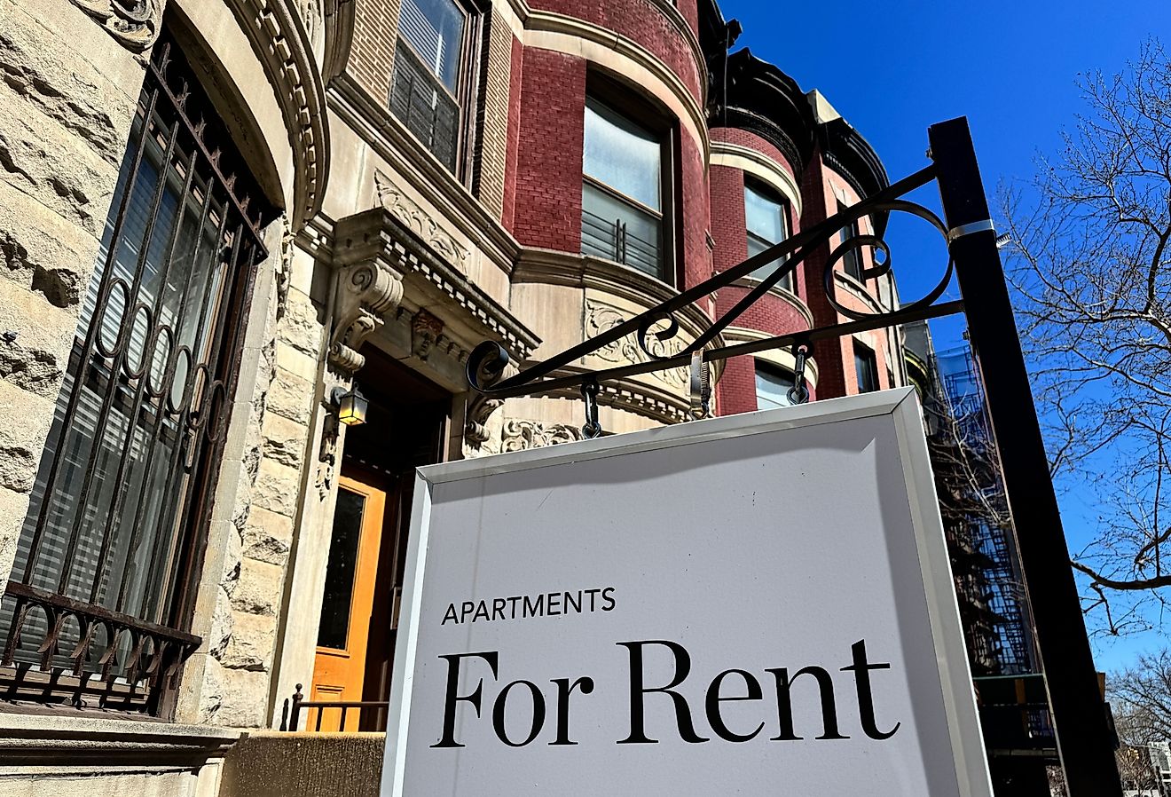 "Apartments for Rent" sign hanging in front of townhouses in Harlem, Manhattan, New York City