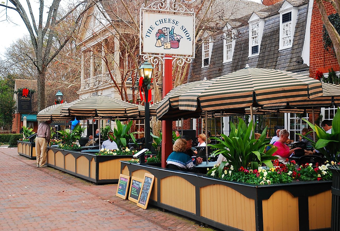 Folks enjoy an alfresco meal in Merchants Square, a retail and dining area near Colonial Williamsburg, Virginia. Image credit James Kirkikis via Shutterstock