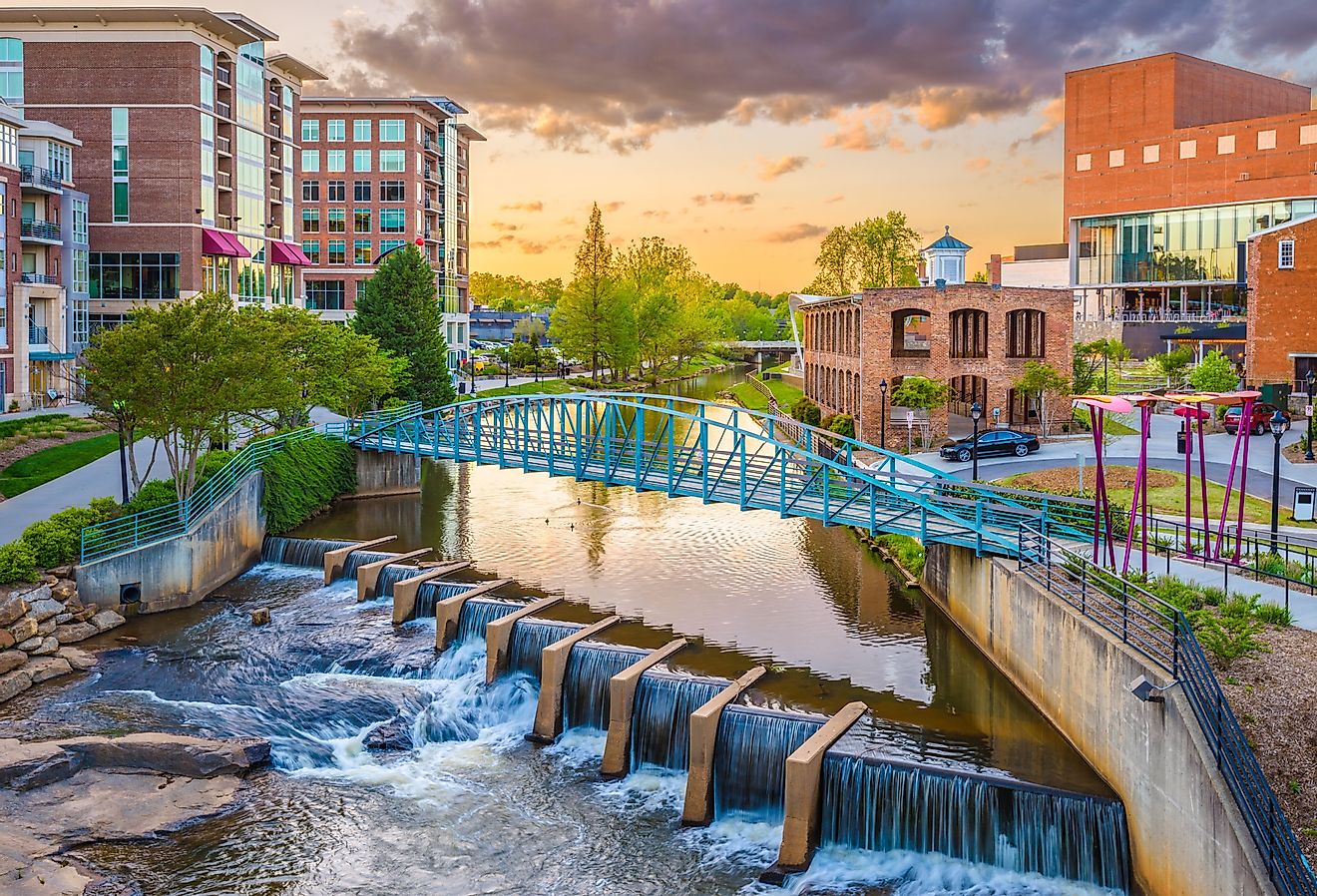 Greenville, South Carolina, downtown cityscape on the Reedy River at dusk.