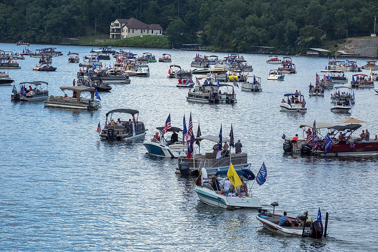 American flags fly in July on Lake Hamilton, Hot Springs, AK. Via Shutterstock / mwesselsphotography.