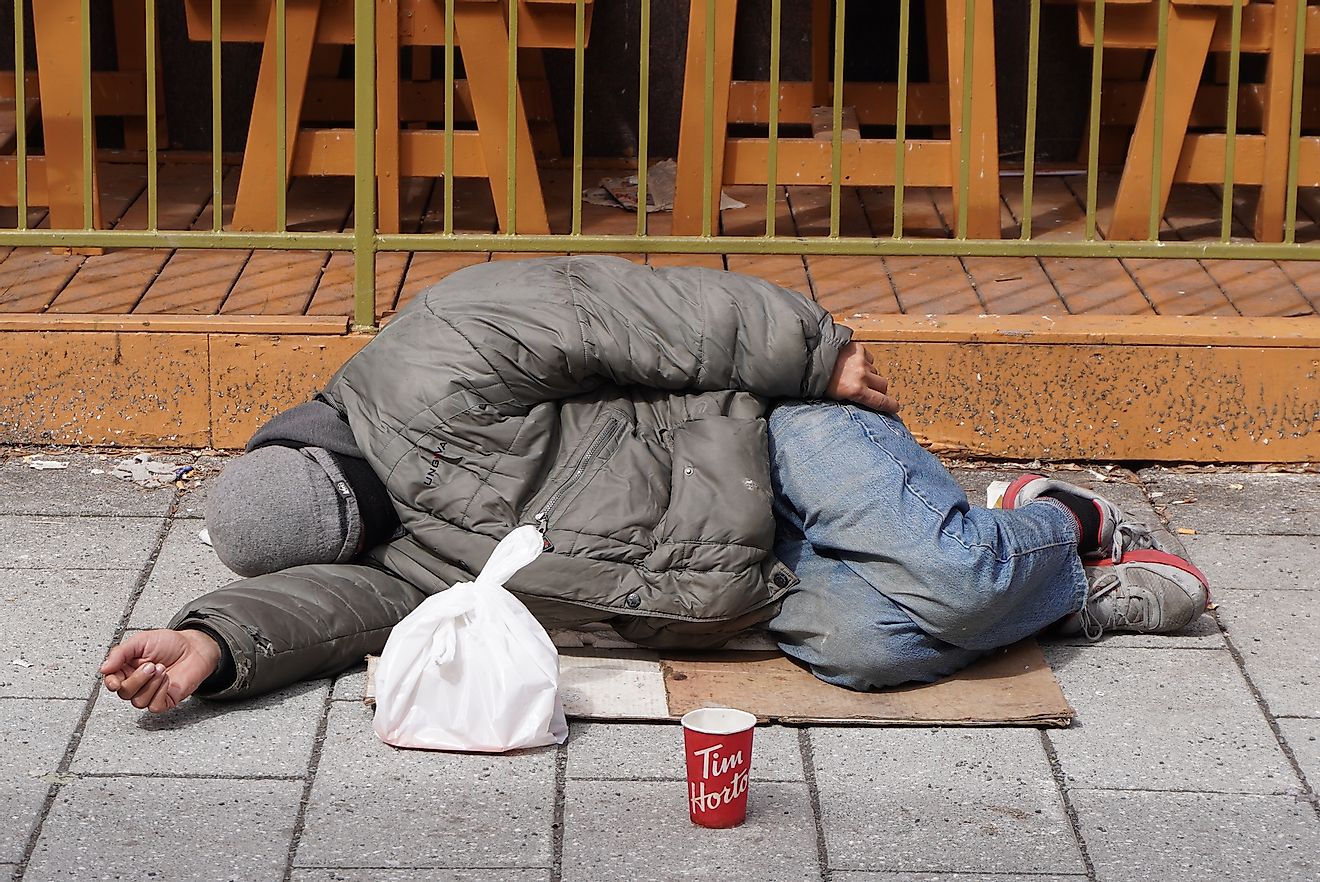 A homeless man sleeping on the street in Montreal, Quebec, Canada. Image credit: 1975boomerang/Shutterstock