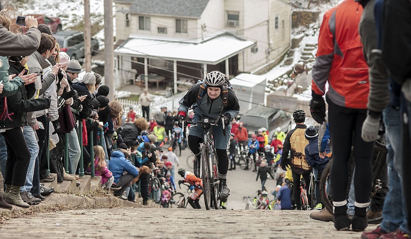  Riders struggle to make it to the top of Canton Avenue in Pittsburgh, one of the steepest residential street in the world. Editorial credit: jefftakespics2 / Shutterstock.com