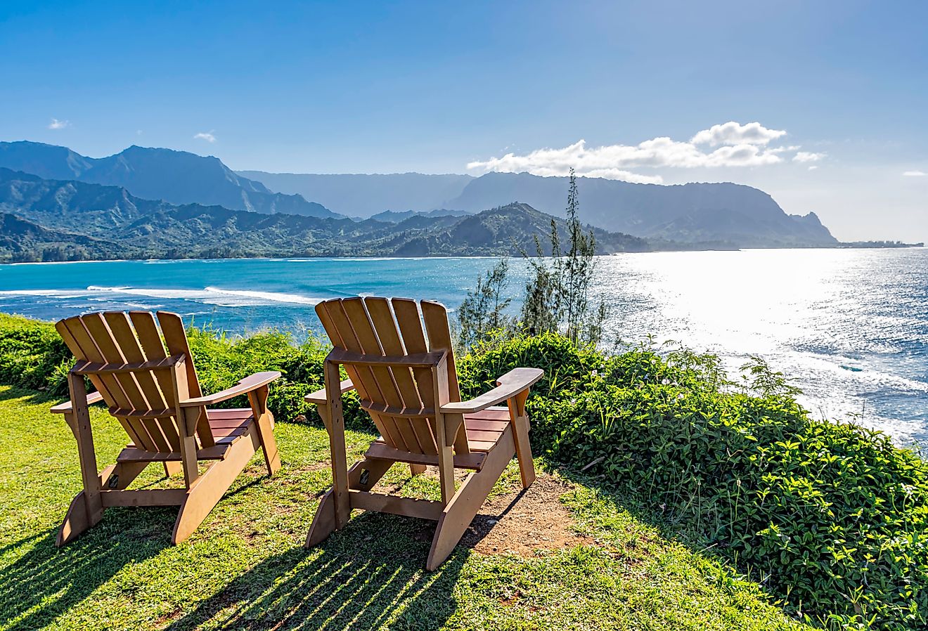  Lounge chairs overlooking Hanalei Bay and the Na Pali coast Princeville Kauai Hawaii USA in the late afternoon sun