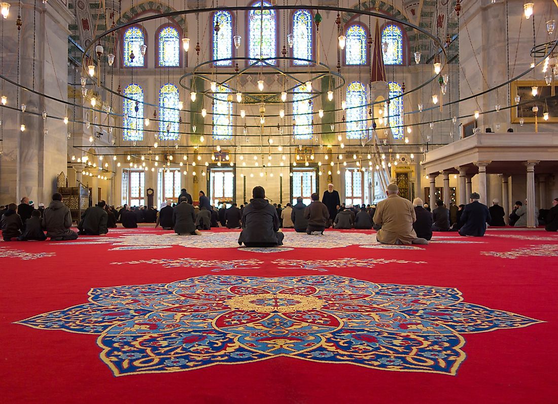 Muslim men gather in Fatih Mosque, a mosque that has existed in Turkey since the year 1470. Editorial credit: Sufi / Shutterstock.com.