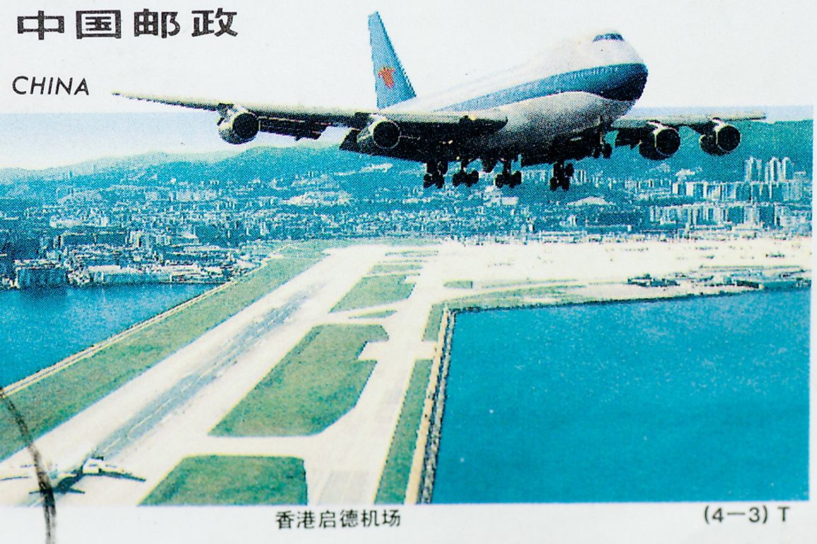 A stamp showing the once-harrowing but now demolished Kai Tak Airport in Hong Kong.Editorial credit: HUANSHENG XU / Shutterstock.com.