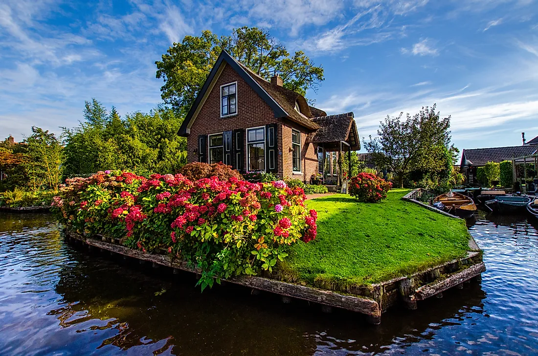 Lines of personal boats "parked" outside of beautiful family homes and Dutch gardens in Giethoorn, the “Venice of the North”.