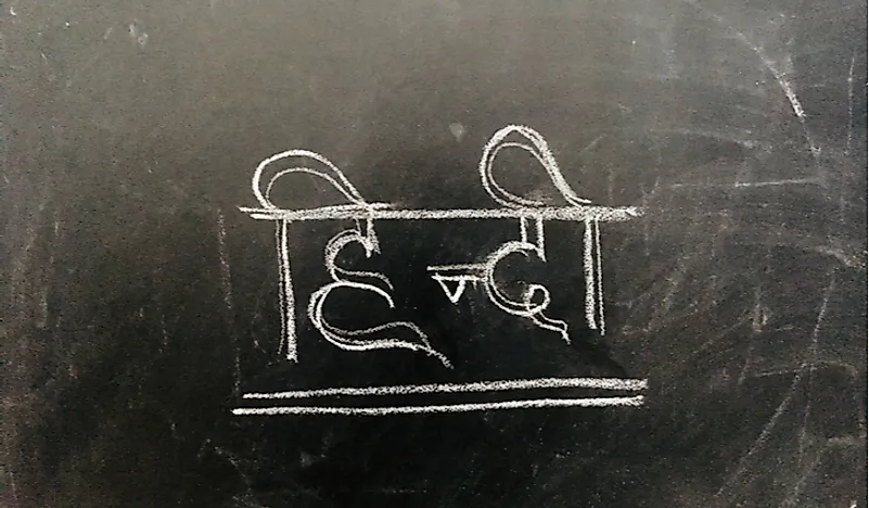 The words "Hindi language" written in Hindi on a blackboard. 