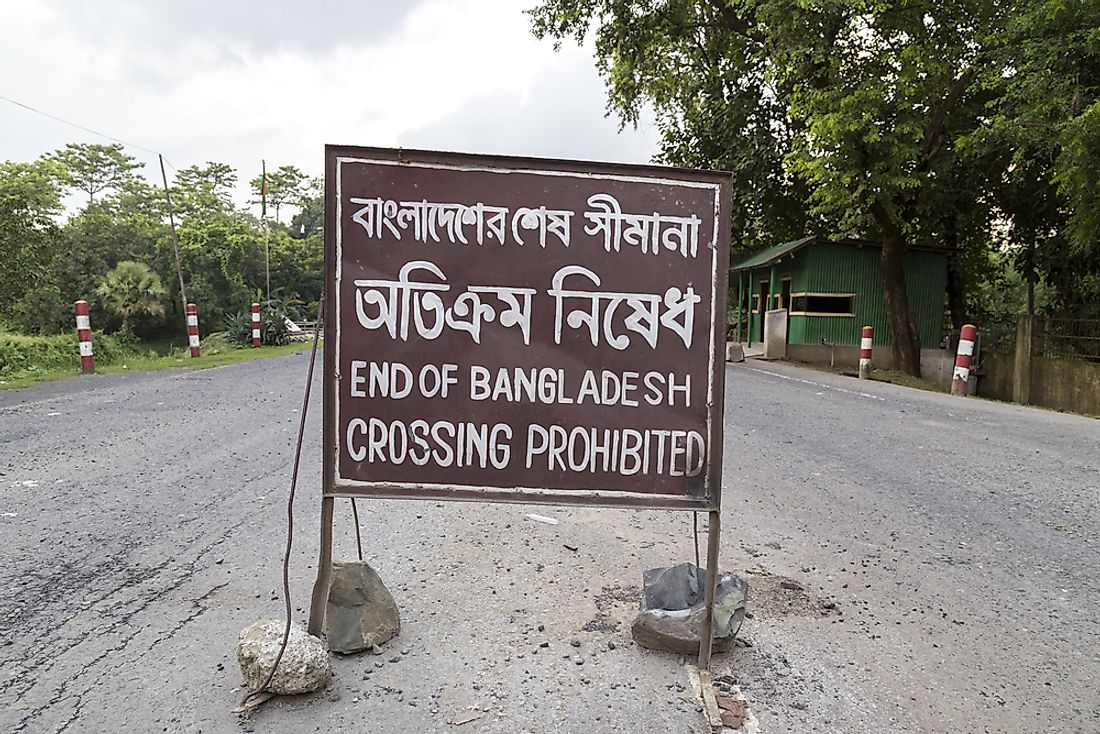 Sign marking boundary line between Bangladesh and India. Editorial credit: MissRuby / Shutterstock.com