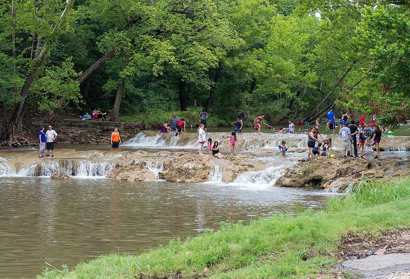 People enjoying the water at Honey Creek near Turner Falls, Oklahoma. Image credit Ivan Malechka via Shutterstock