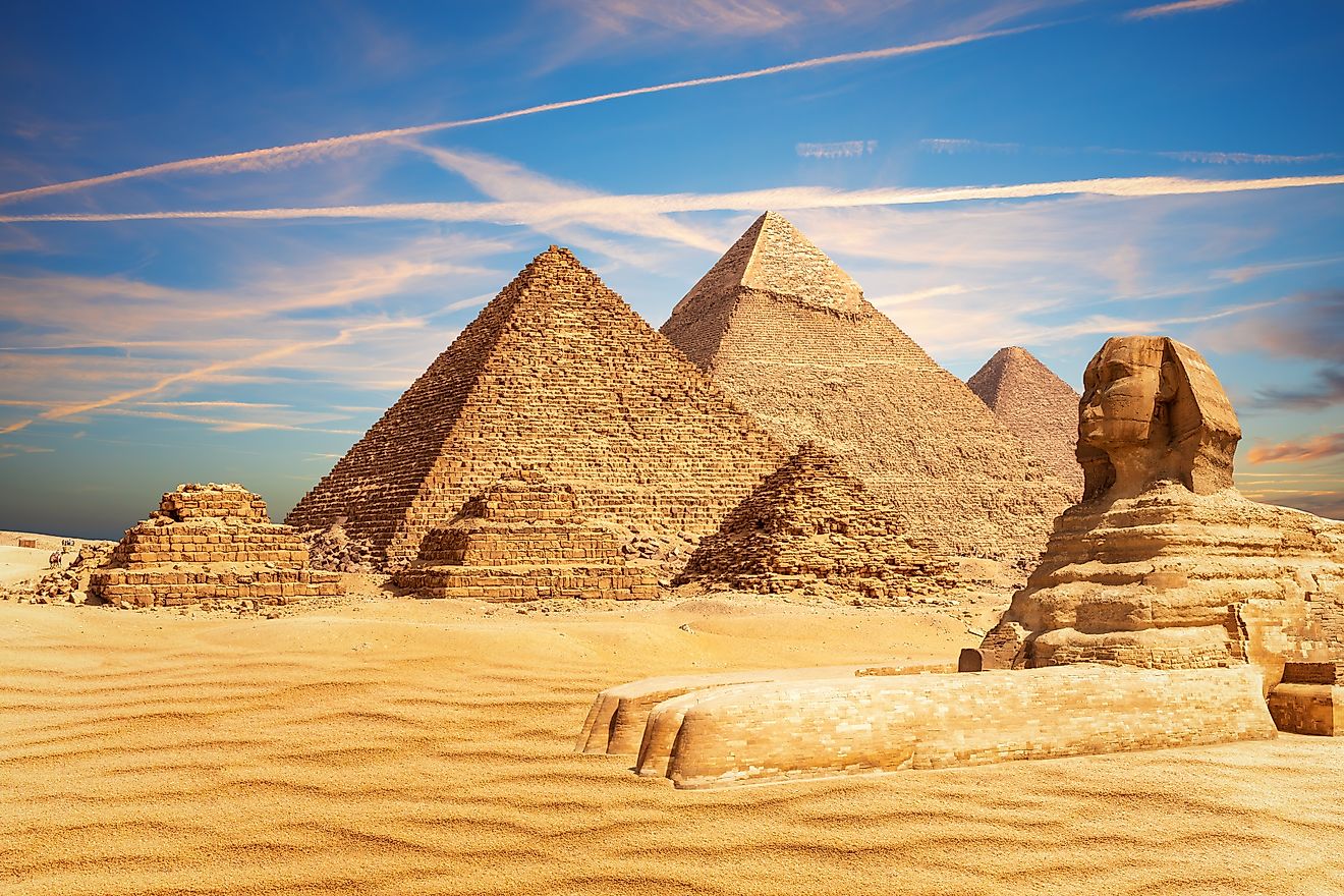 The Great Sphinx sits majestically by the Pyramids of Egypt in the Giza desert.