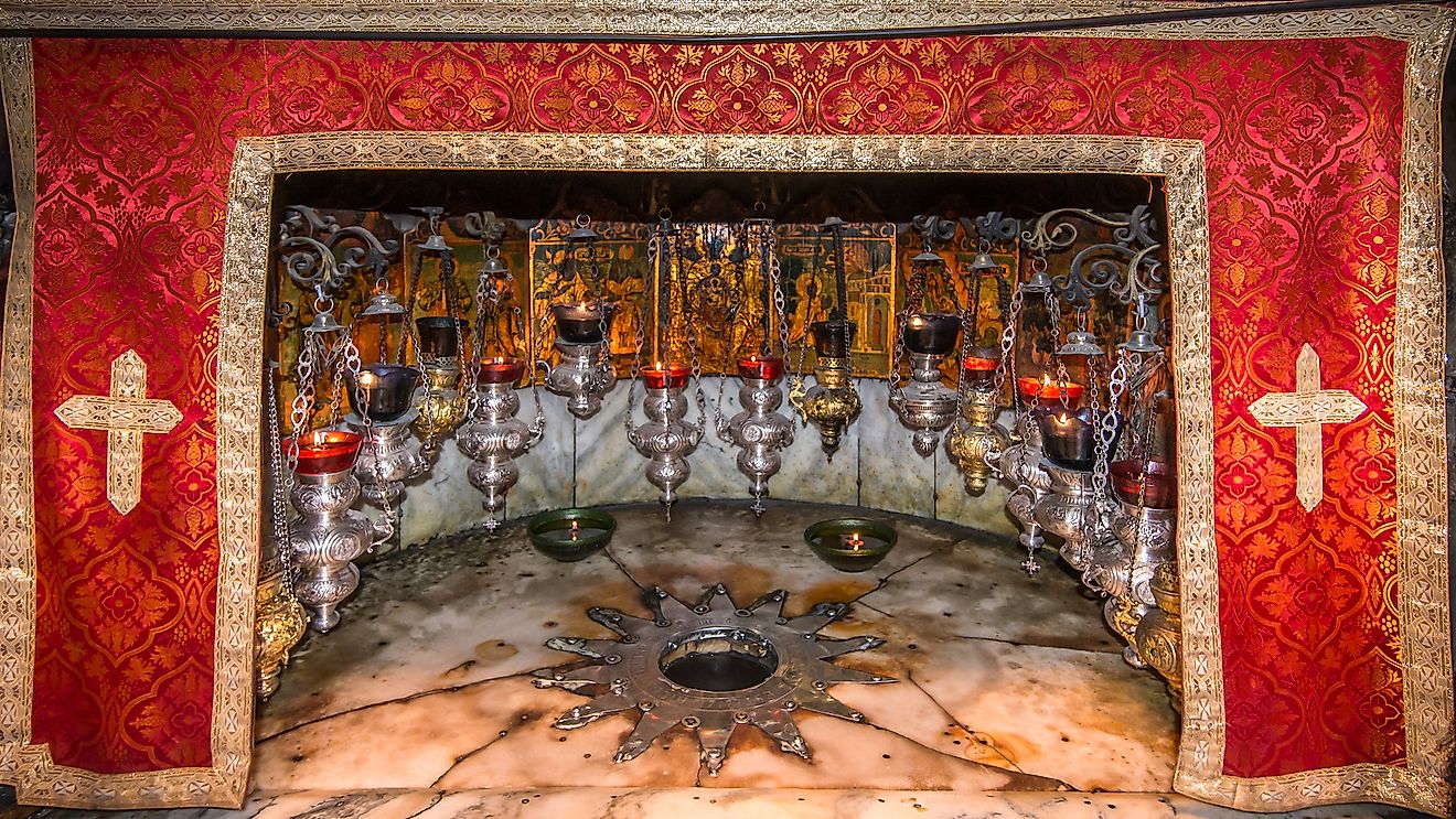 A silver star marks the site of the birth of Jesus (Luke 2:7) in a grotto underneath Bethlehem's Church of the Nativity. Image credit: Steve Lagreca/Shutterstock.com