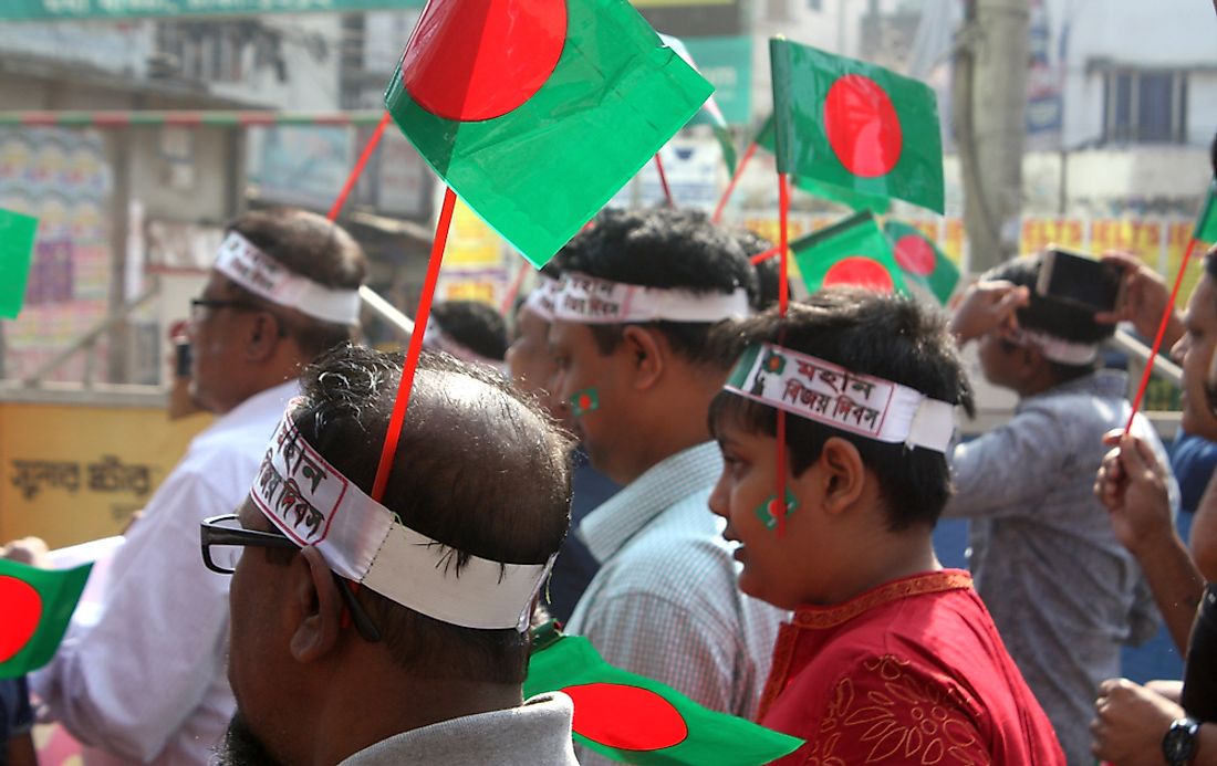Bangladeshi men marching in the Victory Day Rally. Editorial credit: Brand Kidz / Shutterstock.com. 