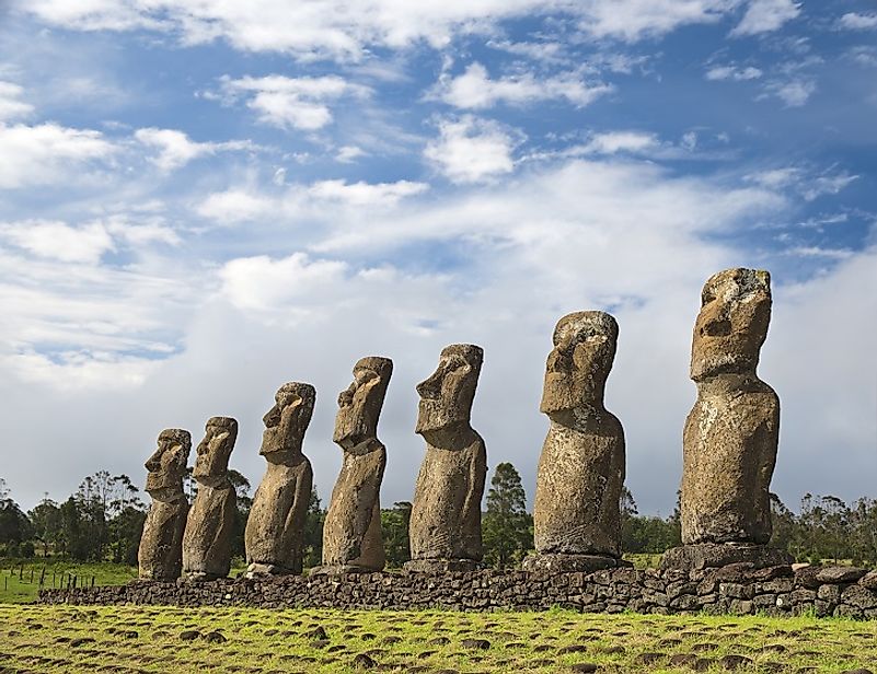 A row of centuries-old Moai (Easter Island heads) stand upon their stone foundations on Easter Island.