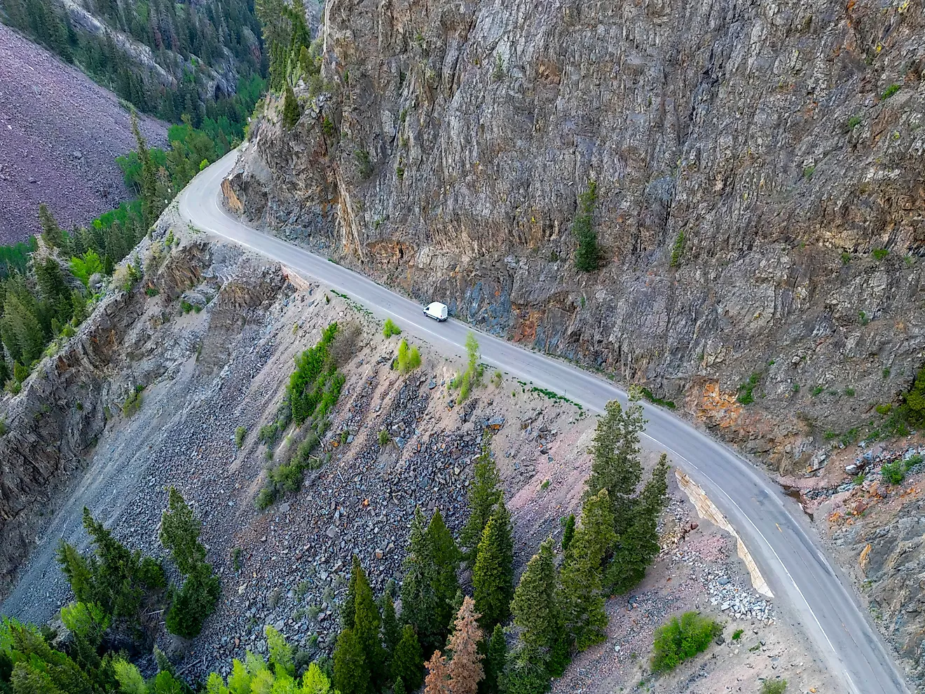 A lone vehicle drives along the dangerous Million Dollar Highway at Ouray, Colorado