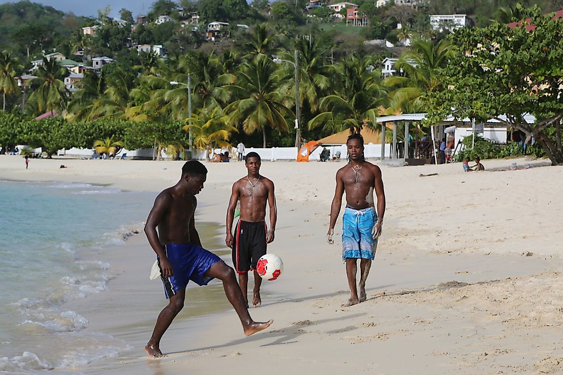 Men play soccer on the beach in Grenada. Editorial credit: Leonard Zhukovsky / Shutterstock.com. 