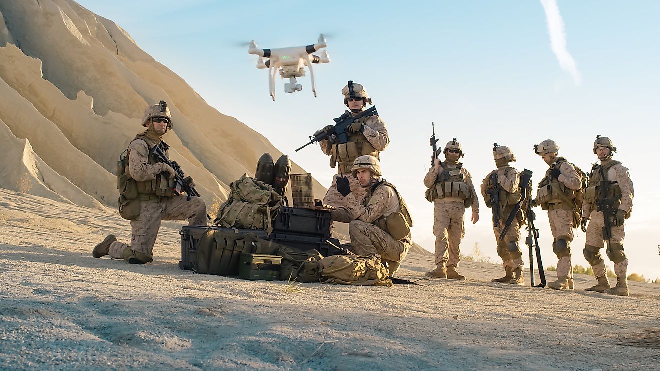 Soldiers are using drone for scouting during military operation in the desert.