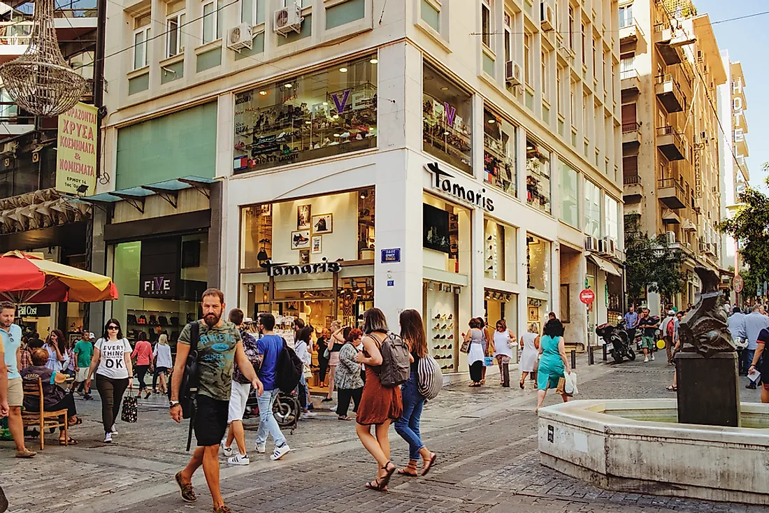 People walk down a street in Athens, Greece. Editorial credit: Nataliia Sokolovska / Shutterstock.com.