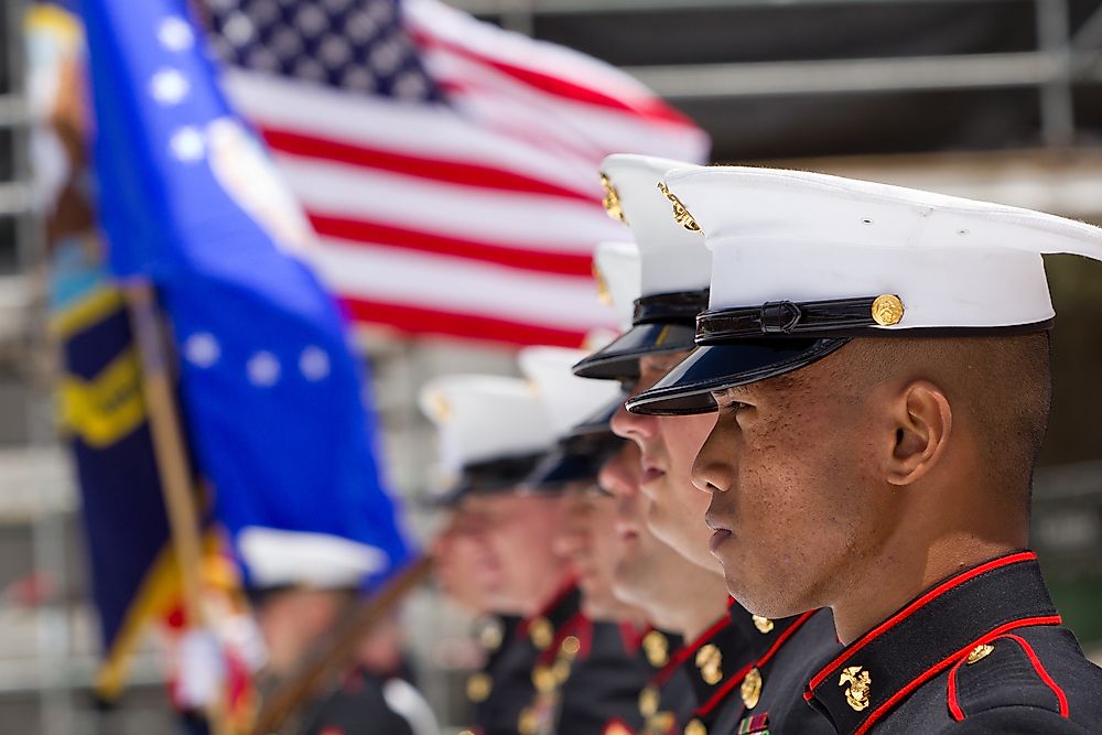 U.S. Military servicemen stand for the singing of the Star Spangled Banner. Editorial credit: Infinite_Eye / Shutterstock.com.