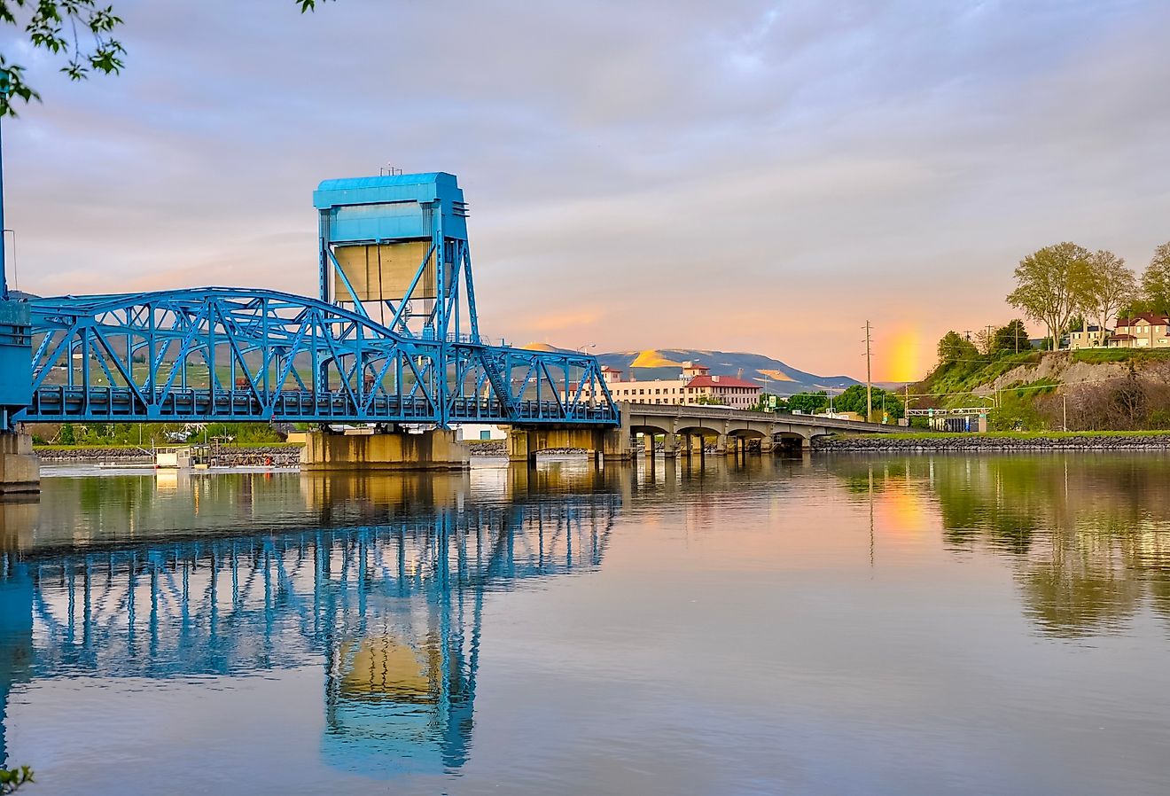 Lewiston-Clarkston blue bridge reflecting in the Snake River against evening sky, Lewiston, Idaho.