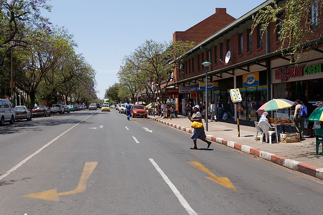 People walk on a street in Francistown, Botswana. Editorial credit: Artush / Shutterstock.com.