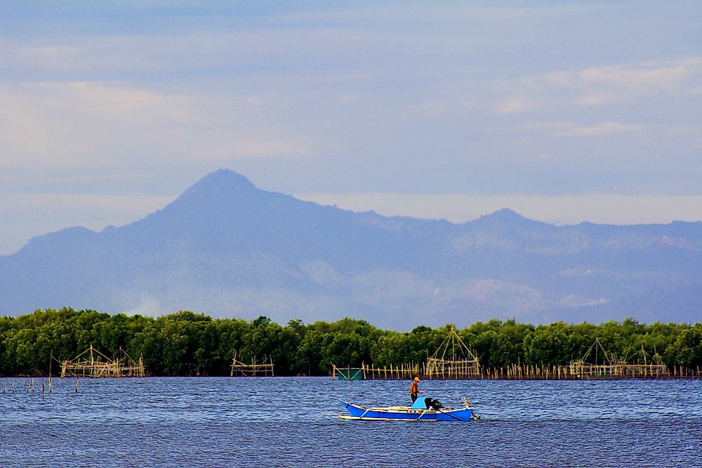 Fisherman in the Strait Of Makassar, between the Borneo and Sulawesi islands in Indonesia. 