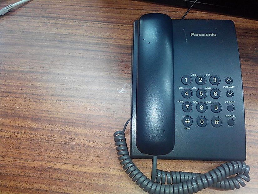 A fixed telephone at a desk.