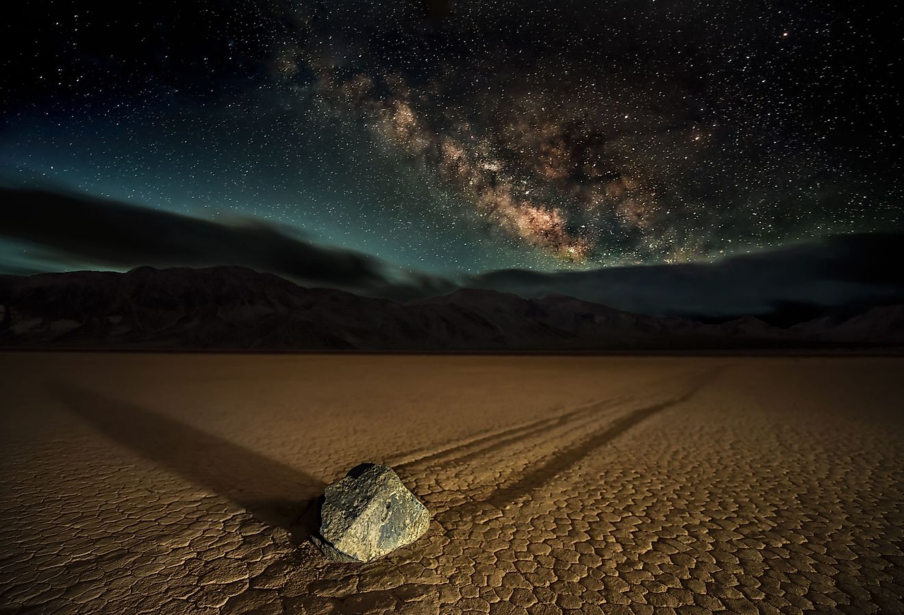 Racetrack Playa. A 'Sailing Stone' photographed at night under the Milky Way at California's Death Valley National Park at the Racetrack Playa. An alien, eerie, and mysterious spectacle.