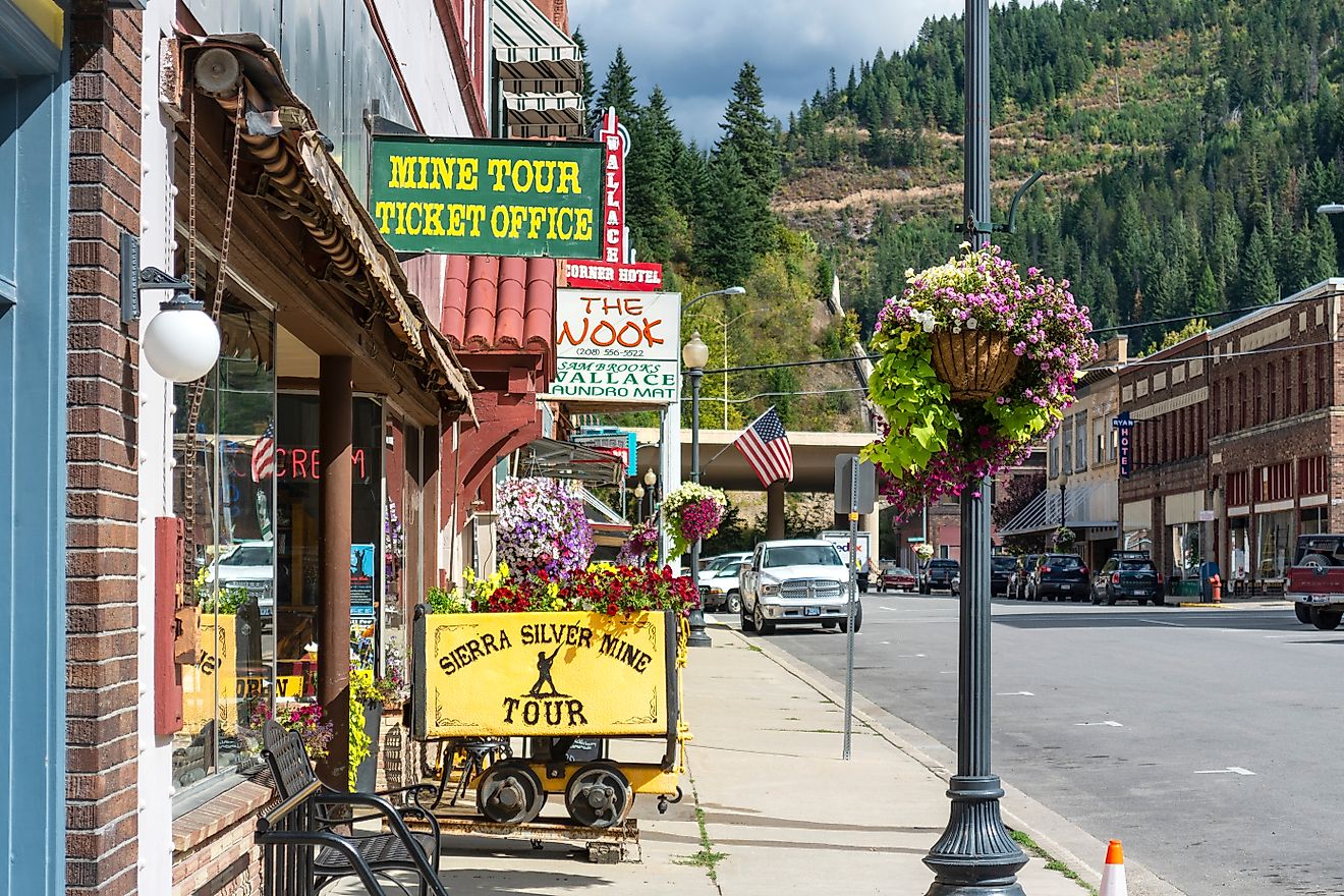 General view of the Sierra Silver Mine tour sign on a sidewalk in the historic mountain town of Wallace, Idaho.