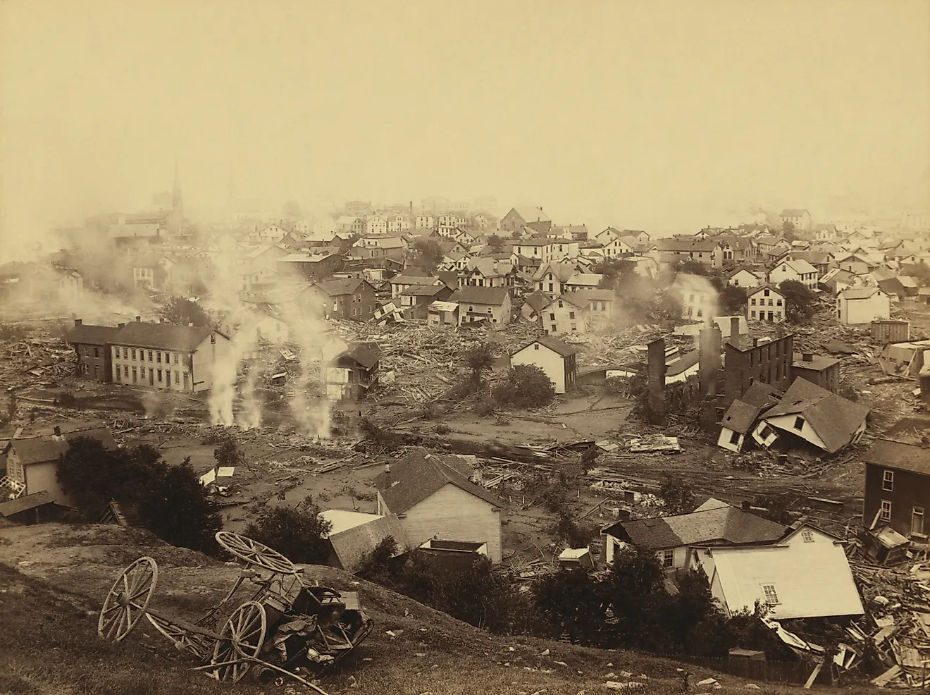 General view of Johnstown from high ground after the flood of May 31st, 1889. Horse drawn wagons and men work in the central mid-ground, possibly recovering bodies Editorial credit: Everett Collection / Shutterstock.com 