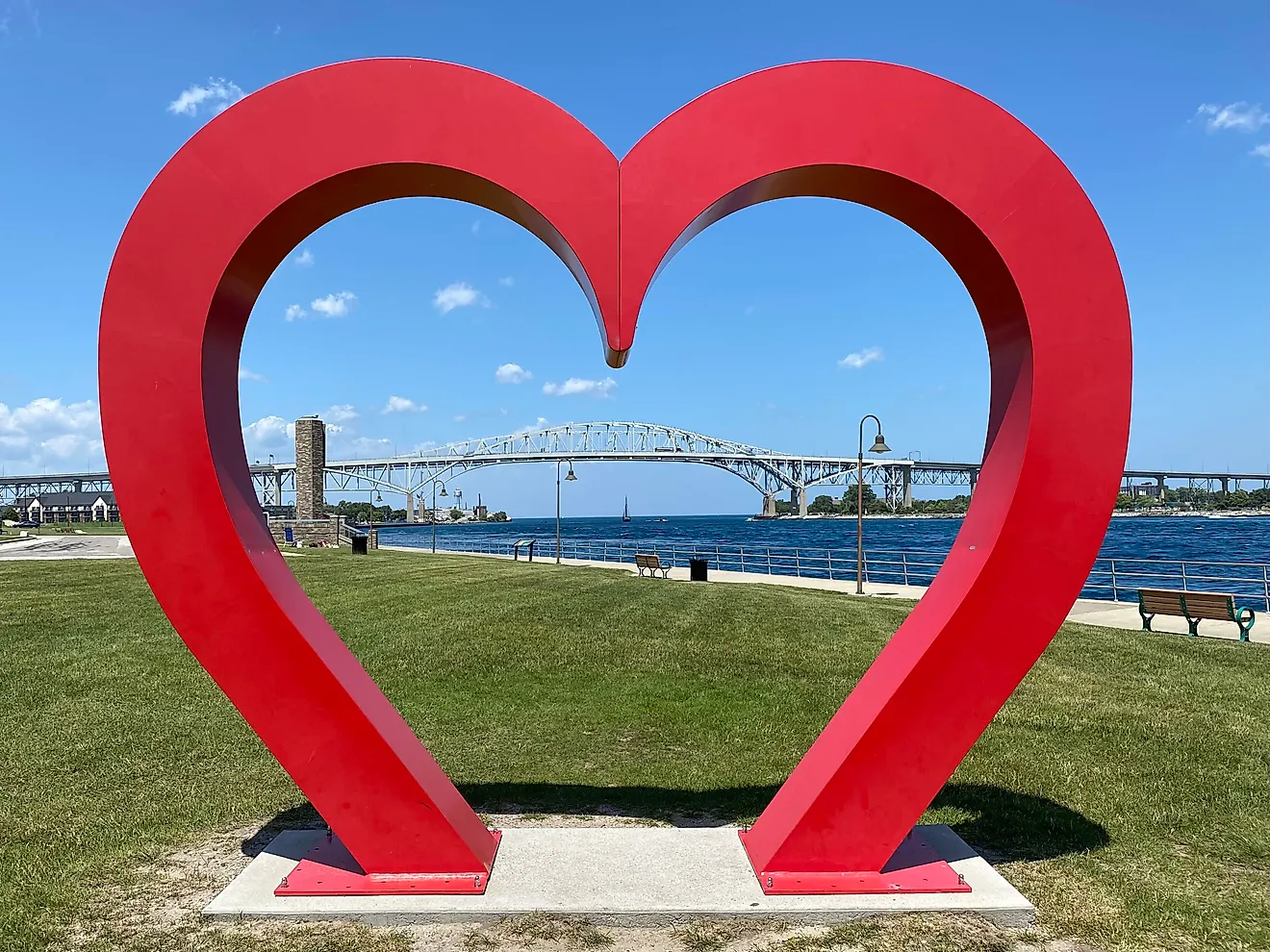 A heart sculpture frames the Blue Water Bridge, an international crossing shared by Michigan and Ontario.