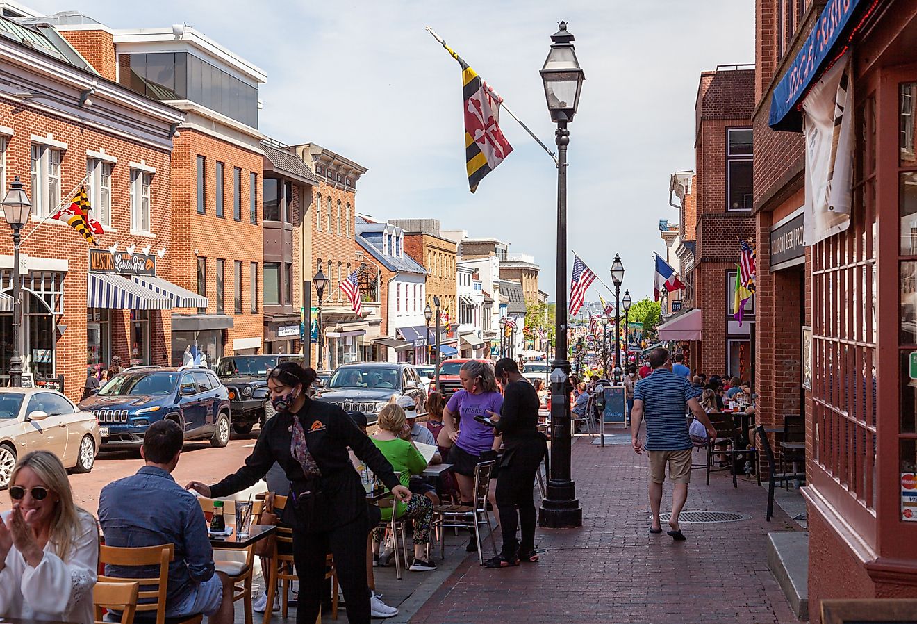 Street view of Annapolis, Maryland, with people walking in the historic town and people dining outdoors. Image credit grandbrothers via Shutterstock