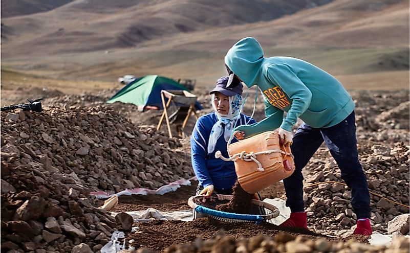 Mongolians manually extract gold from a dried river bed. Editorial credit: J_K / Shutterstock.com