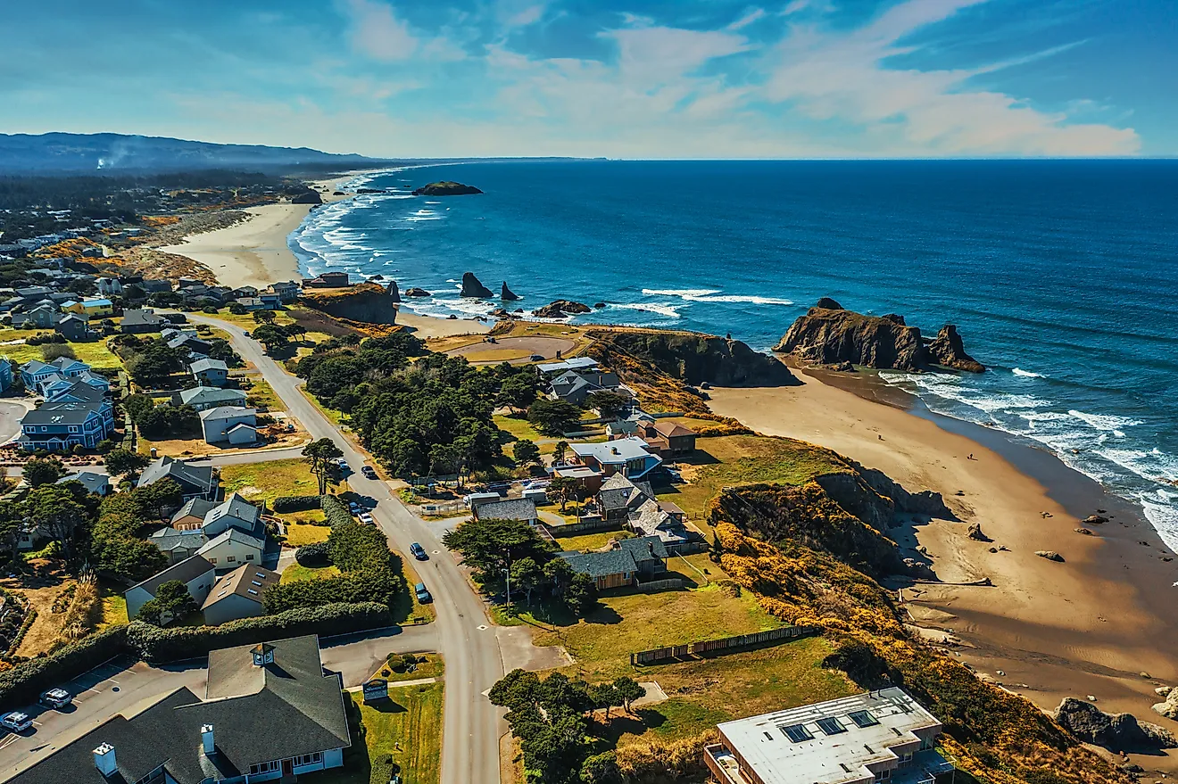Aerial drone shot of coastal homes and beach in Bandon, Oregon.