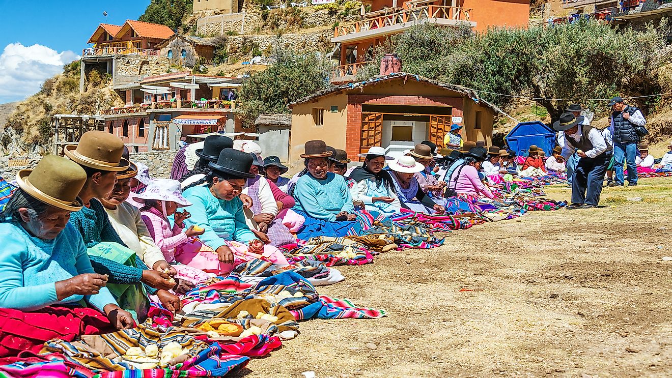 Indigenous Aymara women on Island of the Sun, Bolivia offering food to anyone who wants it.