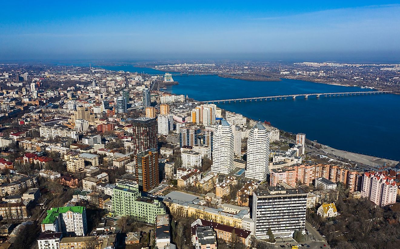 Aerial view of Dnipro city with the Dnieper River and different building blocks.