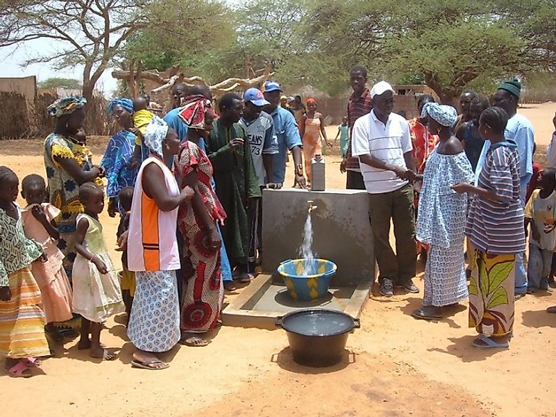 Workers from the United Nations Development Program assisting well installation efforts in Gambia.