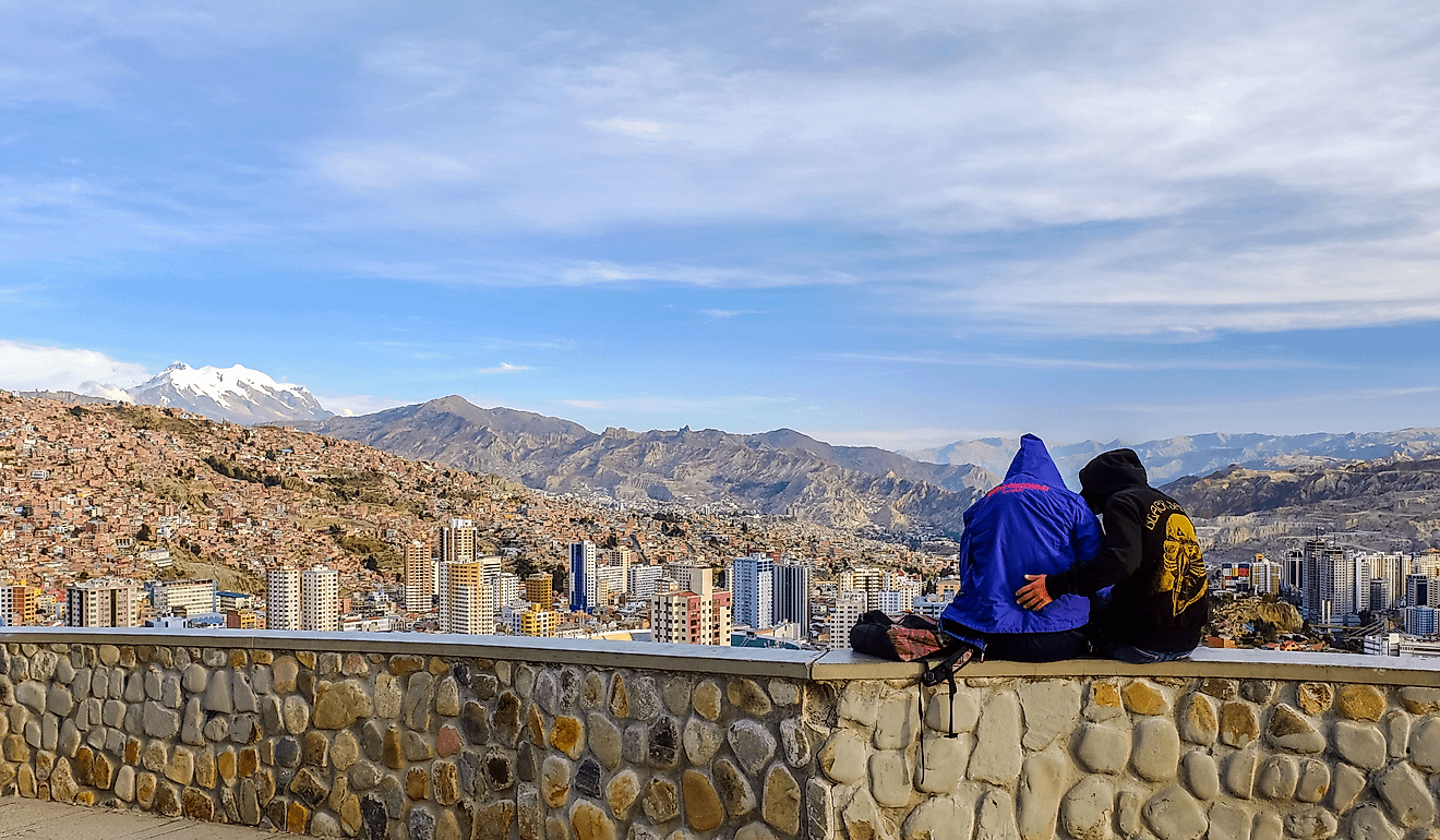 People enjoying the cityscape view from Mirador Killi Killi in La Paz, Bolivia. Image Credit ichywong via Shutterstock.