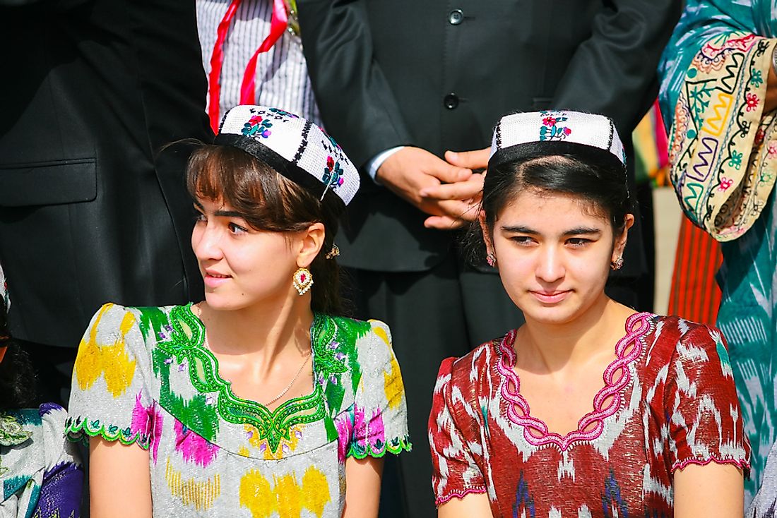 Women dressed in traditional Tajik dresses and hats. Editorial credit: Viktoria Gaman / Shutterstock.com.
