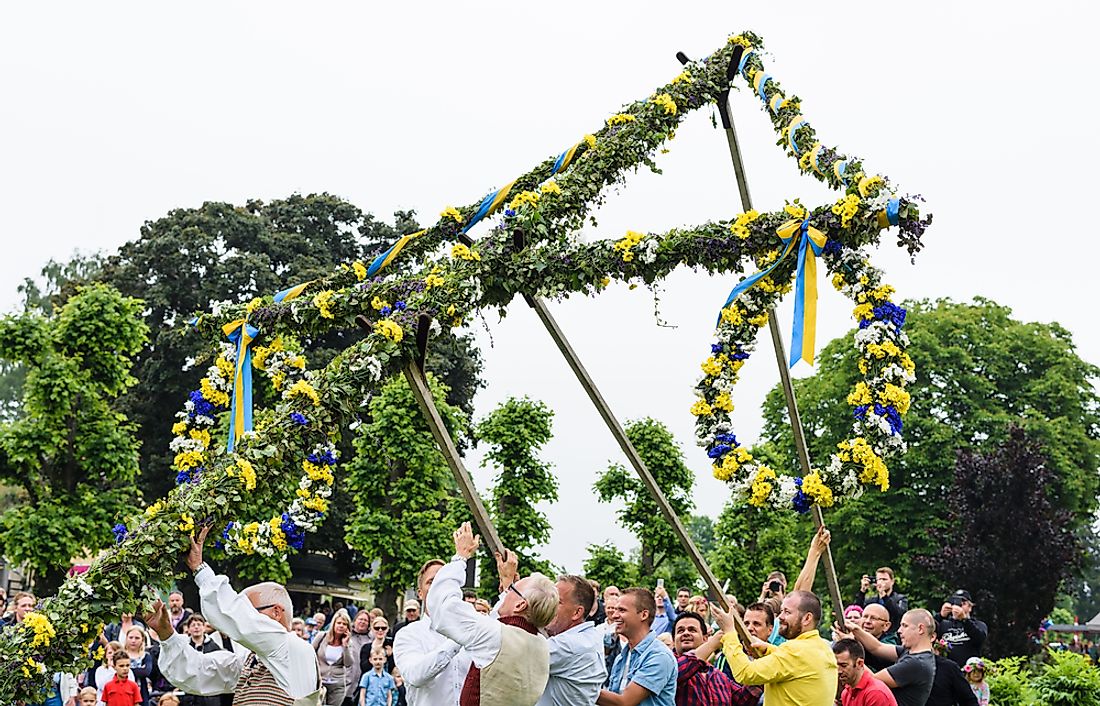 The rising of the maypole, a traditional Swedish tradition. Editorial credit: Ove Nordstrom / Shutterstock.com.