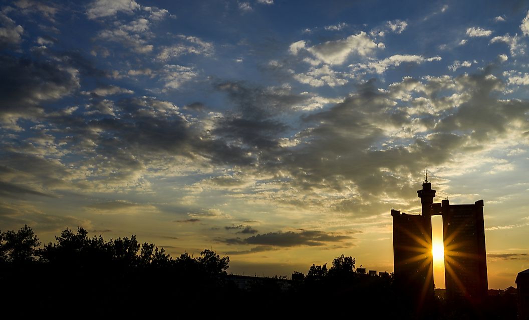 The brutalist silhouette of Western City Gate seen in the distance. 