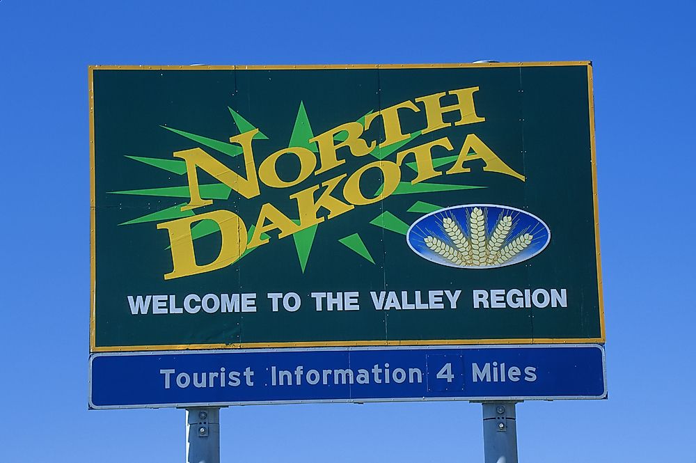 A sign welcoming visitors to North Dakota. 