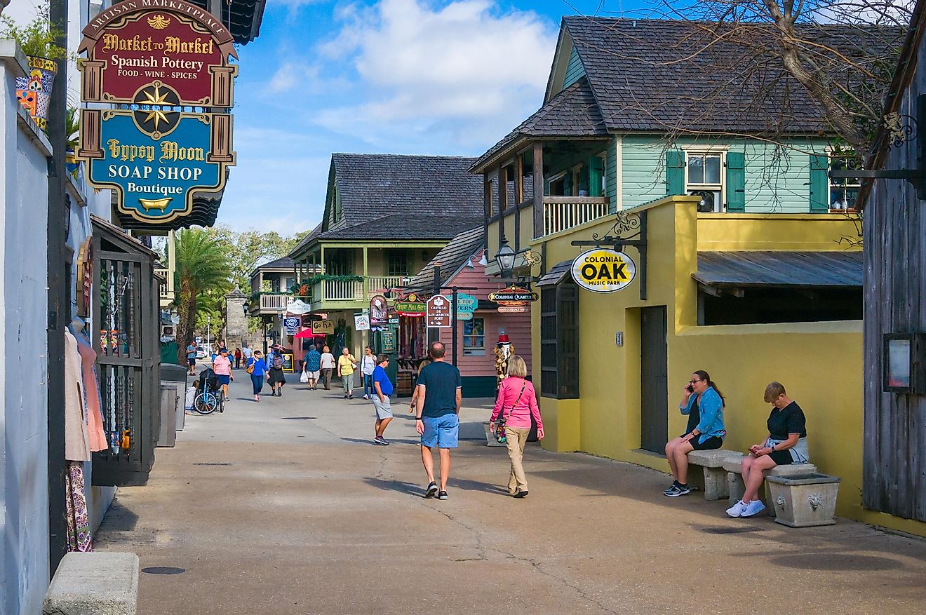 A few tourists walk along St. George street in St. Augustine, Florida, via KenWiedemann / iStock.com