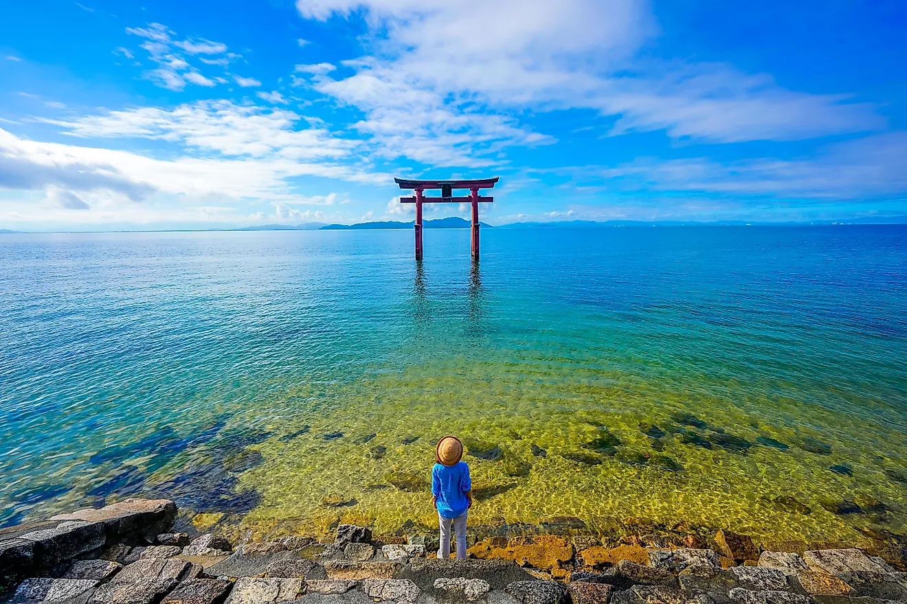 traveler woman and torii gate at Lake Biwa, Shiga Prefecture, Japan