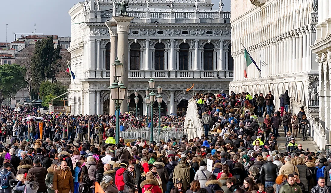 Tourists crowd the Riva degli Schiavoni waterfront in Venice, Italy. Editorial credit: Jaroslav Moravcik / Shutterstock.com